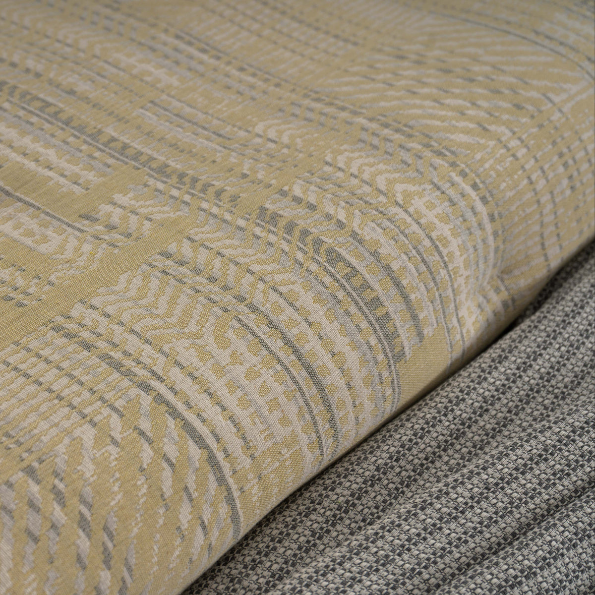 Pormenor do padrão jacquard e da textura do Edredão Conforter Vika Limão