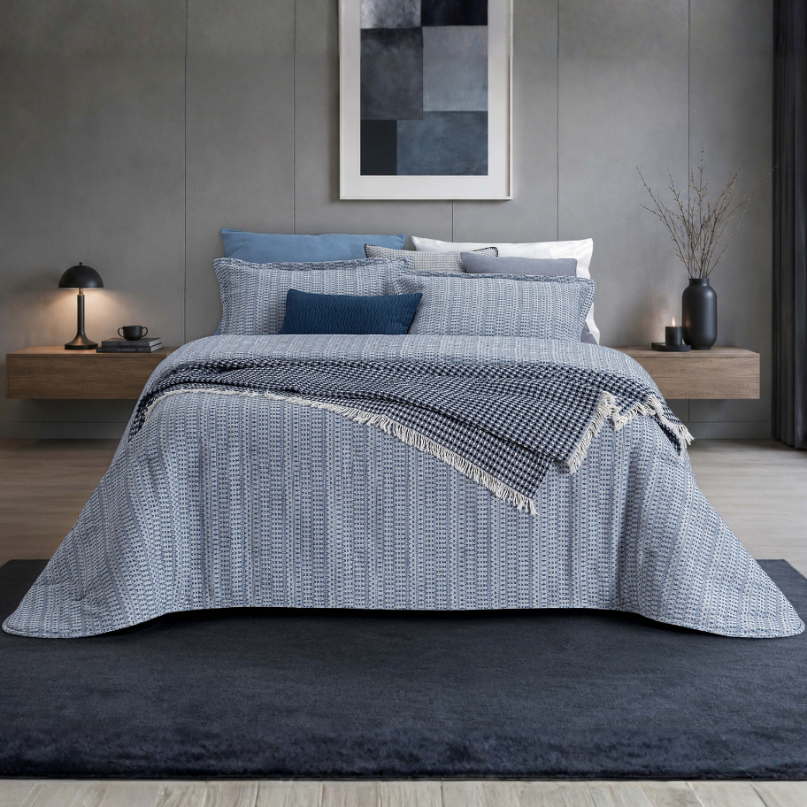Edredão Conforter Calen Azul em jacquard, apresentado numa cama de casal